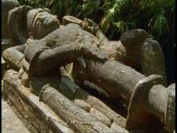 Reclining god statue in forest, Bandhavgarh National Park, India Stock Footage