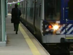 MS, Man running on railroad station platform along moving train, Chappaqua, New York State, USA Stock Footage