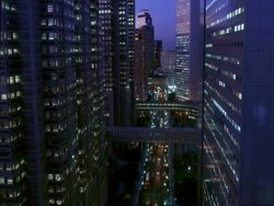 MS view looking down to road from between two buildings, Shinjuku west side, Tokyo, Japan Stock Footage