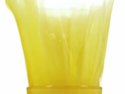 CU SLO MO Orange falling into glass of orange Juice and juice Splashing / Vieux, Normandy, France  Stock Footage