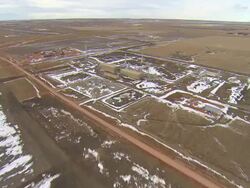 WS AERIAL Shot of passing over oil processing facility at Bakken oil field in snowy fields near Watford City / Watford City, North Dakota, United States Stock Footage