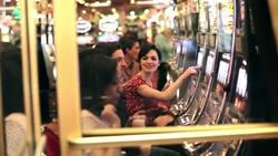 Friends play slot machines in Las Vegas casino Stock Footage