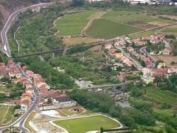 WS AERIAL View of houses, bridge and highway at Espira de L'Agly city / Languedoc Roussillon, France Stock Footage