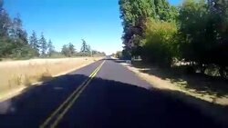 A vehicle traveling on a rural road in the San Juan Islands during a warm summer day near Lime Kiln State Park. Stock Footage