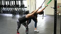 Determined women pulling resistance bands in gym Stock Footage