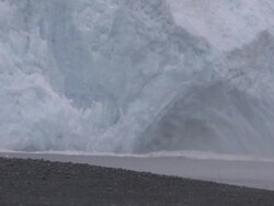 'Wide Shot hand-held-Chunks of ice splash into the sea as a glacier calves. / Kenai Peninsula, Alaska, USA' Stock Footage
