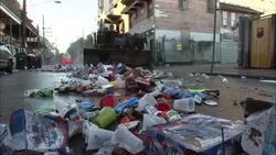 A bulldozer scoops trash from a street in New Orleans. Stock Footage