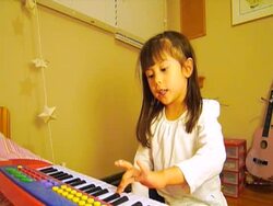 Little girl plays piano Stock Footage