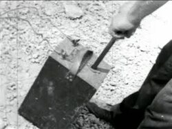 B/W 1934 CANTED close up hands pushing plunger in WPA sewage construction project / documentary Stock Footage