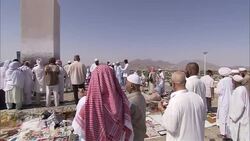 Muslims gather near a white pillar, a sacred site, in Saudi Arabia. Stock Footage