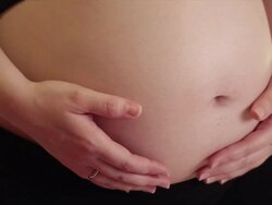 Pregnant woman caressing her bellyb, close-up Stock Footage