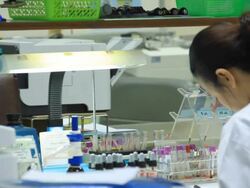 Scientists loading sample vials into centrifuge. Stock Footage