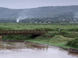 Exterior pan from right to left of river with view of hills.  Travel destination Stock Footage