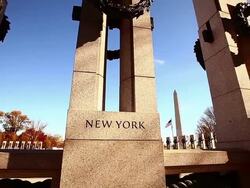 Dolly shot of World War II Memorial pillars in Washington DC with lens flare Stock Footage