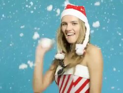 Young Woman Santa helper Throwing Snowball Stock Footage