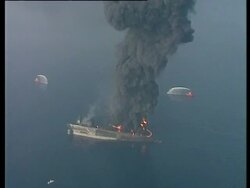 Aerial of Haven oil tanker on fire at sea with plumes of thick black smoke Genoa, Italy, Mediterranean. Stock Footage