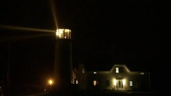 Lighthouse beams search a dark sky. Stock Footage