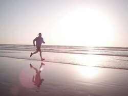 Jogging at the beach Stock Footage