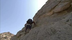 Archaeologists climb to a Roman fort in Shenshef, Egypt. Stock Footage