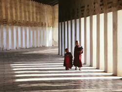 WS Shot of Novice Monks dressed in traditional clothes in Walkway to Shwezigon Pagoda / Bagan, Burma  Stock Footage