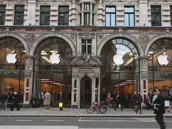 WS Buses moving and people waking with Apple flag  waving in breeze,  Apple Store, Regents Street / London, Greater London, UK   Stock Footage