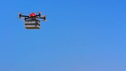 SLO MO UAV transporting a plastic box across blue sky Stock Footage