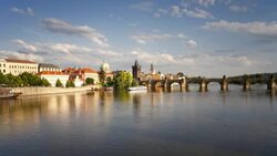 Ferry boats move beneath the Charles Bridge on the River Vltava near Prague Castle. Stock Footage