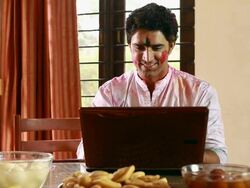Couple celebrating holi festival on the laptop Stock Footage
