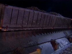 Shot of truck emptying a trailer full of sugar beets into canal. Stock Footage