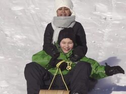Boy and girl have fun sledding Stock Footage