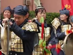 LS CU People performing gongs and drums with costumes/xian,shaanxi,China Stock Footage
