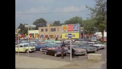 WS Seller showing car to customer in used cars parking lot / United States Stock Footage
