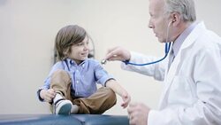 Male doctor checking the heart rate of a young male patient Stock Footage