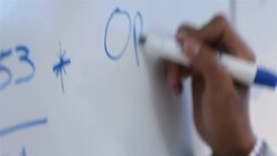 Hip young businessman's hand writes on conference-room white-board Stock Footage