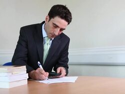 Suited male lawyer signing contracts Stock Footage