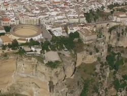 Aerial view of city with bullring and Tajo Bridge, Ronda, Andalusia, Spain Stock Footage