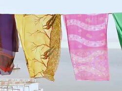WS View of Colorful sarees drying at a ghat near Ganges River / Varanasi, Uttar Pradesh, India Stock Footage