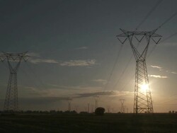 WS View of Electricity pylons crossing fields and Power lines at sunset / Brindisi, Puglia, Italie Stock Footage