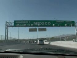April 9 2009 WS View from car approaching Mexican and US border, Juarez, Chihuahua, Mexico, AUDIO Stock Footage