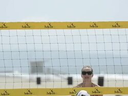 CU of female beach volleyball players spiking and blocking at the net. Stock Footage