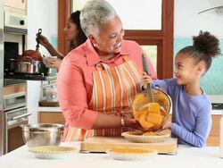 WS Three Generations of Women Cooking Holiday Meal in Kitchen / Richmond, Virginia, USA Stock Footage