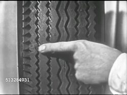 1952: SPONSOR BREAK: CU Gulf tire tread, male finger pointing out even, wide width. MS Bill Rogers sitting at desk talking about written warranty, be sure, safe, Gulf tires.     Early commercials. Instructional Video