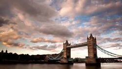 Clouds float over Tower Bridge in London, England, at golden hour. Stock Footage
