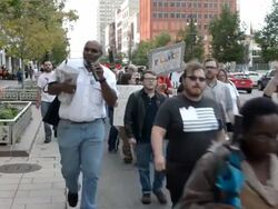 Peace activists march with banner against war Stock Footage