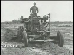 1944: BATTLE OF ENIWETOK: VS U.S. Navy Seabees construction battalion paving roads w/ plower, watering w/ hose, steamrollers & bulldozers operating on incomplete airfield, clearing rocks, spiked steamroller passing. WWII, Pacific Front, Enewetak Instructional Video