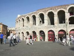 MS PAN Shot of Tourists roaming in front of Arena di Verona at Piazza Bra / Verona, Veneto, Italy Stock Footage