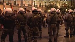 Protesters throw bottles at police as lawmakers vote on tax law News Clip