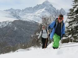 Ground level view of skiers following path through snow Stock Footage