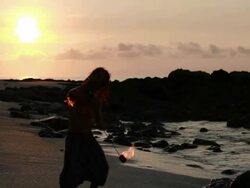 MS Silhuoette of rasta man spinning fire on beach with sunrise  / Montezuma, Punteranes, Costa Rica Stock Footage