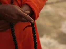 Sage with prayer beads at riverbank, Ganges River, Haridwar, Uttarakhand, India Stock Footage